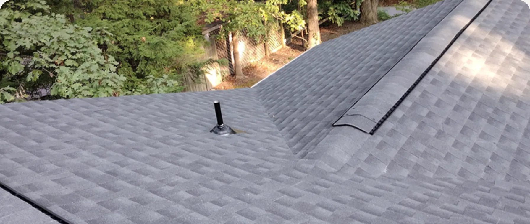Shingle roof with ridge vent and flashing