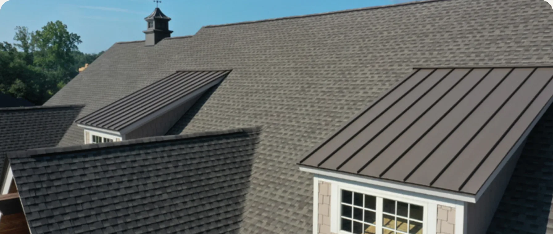 Metal roofing accents on a shingle roof